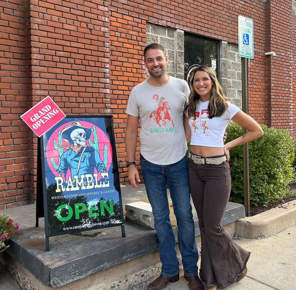 Brett DeJager & Paige Gurtner stand next to their grand opening store sign.