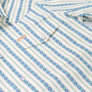 Close-up of a striped shirt with a brand label on a white background