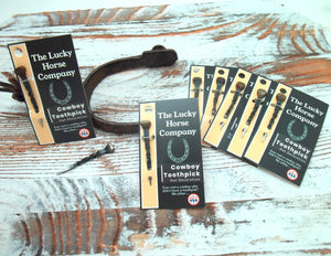 The Lucky Horse Company cowboy toothpick packaging on a wooden surface