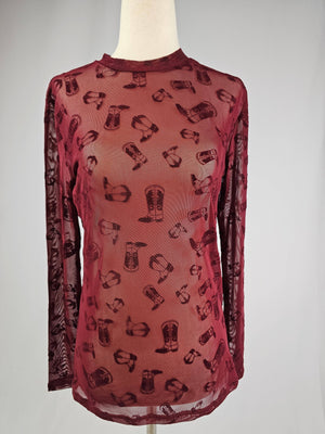 Red sheer top with cowboy boot pattern on a mannequin against a gray background