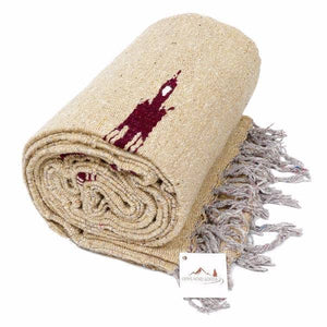 Beige blanket with red design and gray tassels on a white background