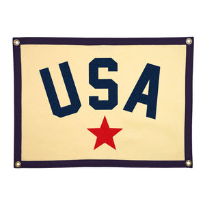A rectangular camp flag with a cream body, featuring the letters 'USA' in navy blue and a red star below, bordered with a navy detail.