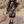 Woman wearing a patterned dress and cowboy boots in a desert setting