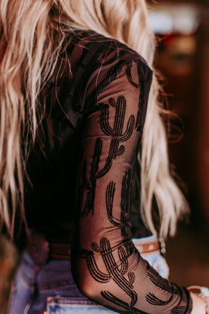 Person with cactus tattoo mesh shirt.