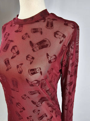 Red long-sleeve shirt with black pattern on a mannequin against a white background