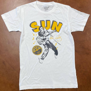 White t-shirt with 'Sun Records' graphic design on a brown surface