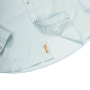 Light blue shirt with a brand label on a white background