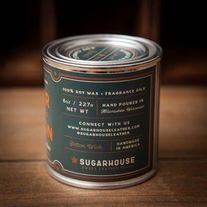 Candle canister with 'Sugarhouse' label on a wooden surface