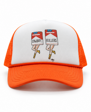 An orange and white trucker hat featuring a graphic on the front panel of two stylized legs stepping over red and white cigarette packs labeled 'COWBOY' and 'KILLERS'.