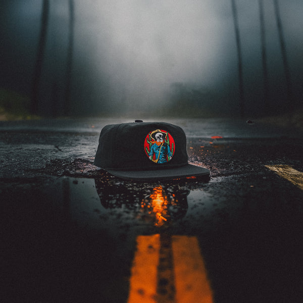 Horseman Black cap on a spooky wet road.