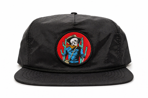 Black cap with a colorful patch featuring a cowboy and skull design on a white background