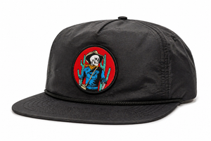 Black snapback with a colorful woven patch of a skeleton cowboy.