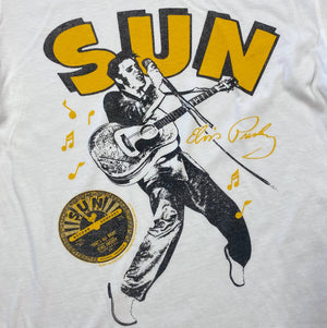 T-shirt with graphic of a person playing guitar and 'SUN' branding on a white background