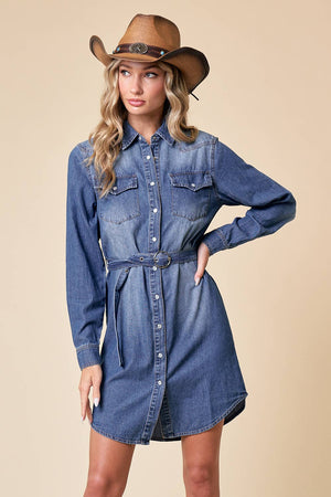 Woman wearing a blue denim dress and brown cowboy hat on a beige background