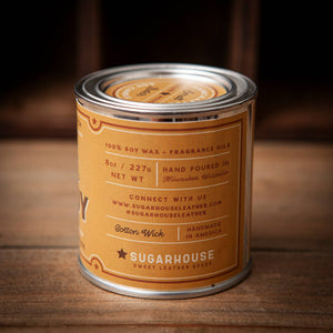 Candle canister with 'Sugarhouse' label on a wooden surface