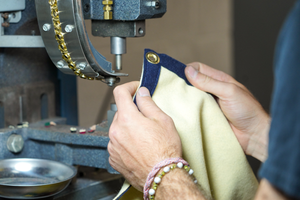 A person's hands as they hold the USA flag/banner.