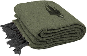 Folded green blanket with a black design on a white background