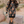 Woman wearing a patterned dress and cowboy boots in a desert setting