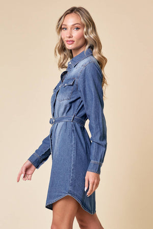 Woman wearing a blue denim dress and brown cowboy hat on a beige background